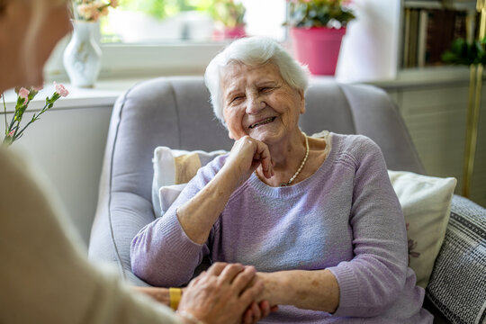 Elderly woman with her caregiver in nursing home 
