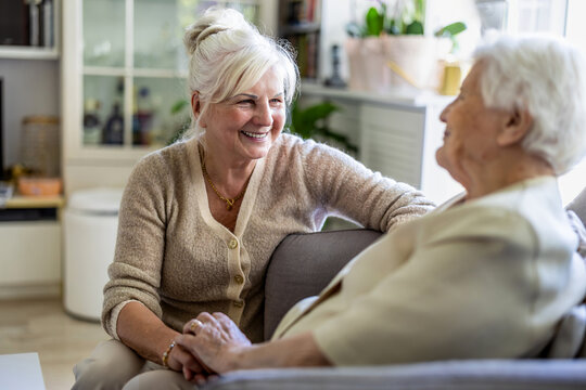 Elderly woman with her caregiver in nursing home 
