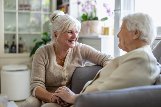 Elderly woman with her caregiver in nursing home 
