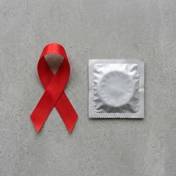 Red Ribbon And Condom For AIDS Awareness And Safe Sex