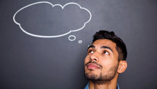 Man gazing thoughtfully at a chalkboard with a drawn thought bubble representing imagination, problem-solving and creative brainstorming