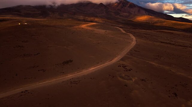 Majestic aerial view of a remote road leading to the chimborazo volcano in ecuador at sunrise