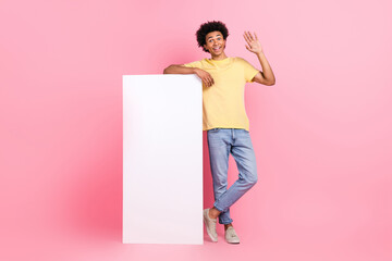 Full body photo of positive cheerful person arm palm waving empty space big poster isolated on pink color background © deagreez