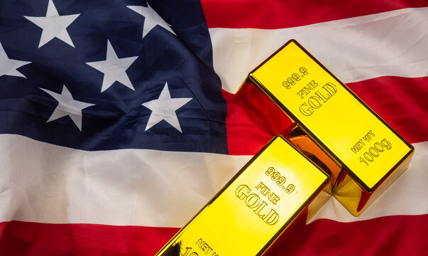 Two Gold bar lies on top of a rippled United States of American flag.
Gold serves as a primary safe-haven asset for investors during economic uncertainty.