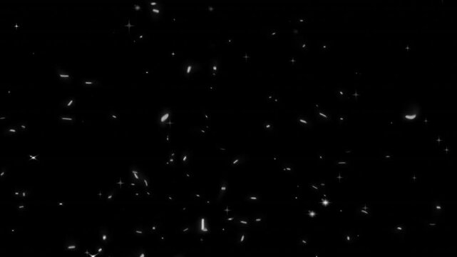 Dust particles and small floating specs scatter randomly across a dark black background in an abstract overlay effect.