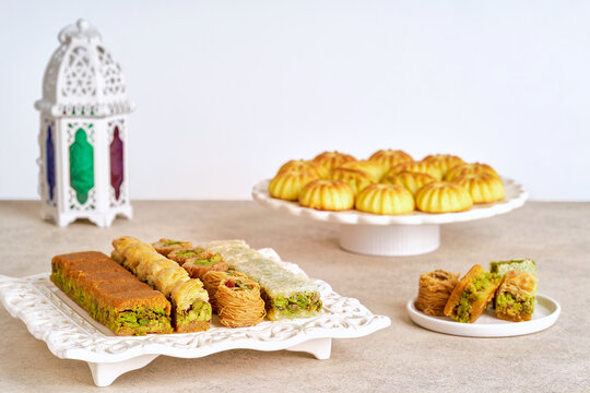 Assorted baklava and semolina maamoul cookies with Ramadan lantern . Traditional arabic sweets