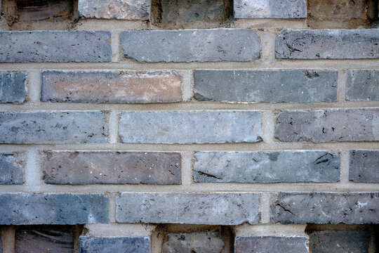 Weathered Gray Brick Wall with Rough Traditional Masonry Texture