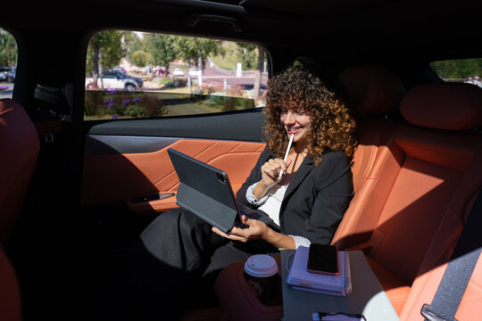 White woman working on digital tablet