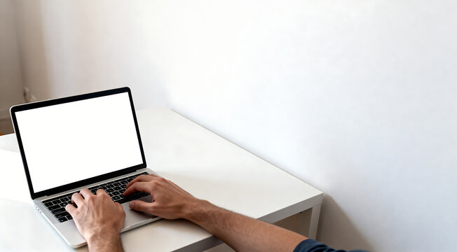 High angle man typing on laptop blank screen