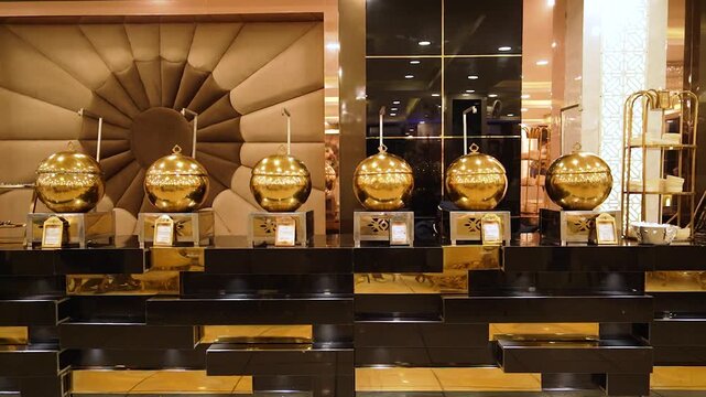 Golden buffet chafing dishes arranged for an Indian marriage event in Ghaziabad