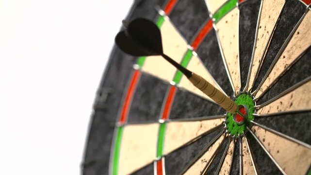 dart in the center of a dartboard on white background. Close Up Red Dart Arrow On Target Center of Dartboard, isolated on white background with clipping path.