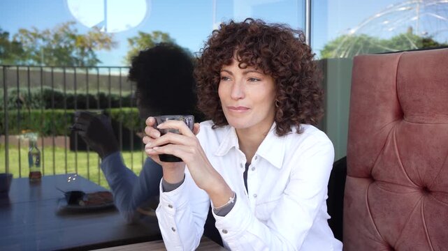 Contemplative Moment Woman Enjoying Coffee in Modern Caf