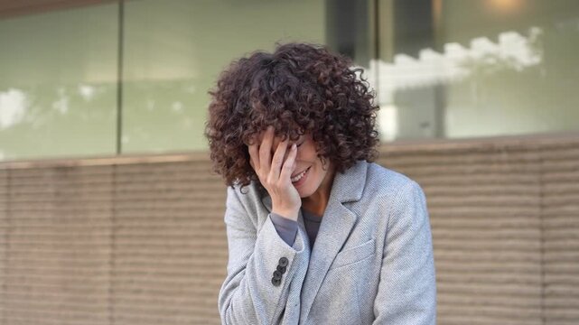 A Portrait of a Confident Businesswoman Showcasing Her Curly Hair and Professional Style