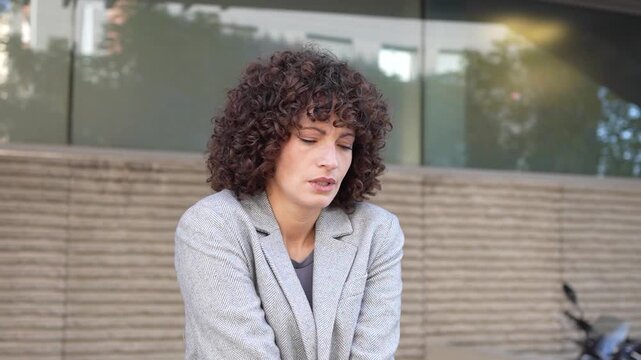 Confident and Accomplished Businesswoman with Beautiful Curly Hair in Professional Attire