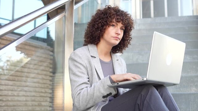 A Professional Woman Engaging in Work on a Laptop While Enjoying the Outdoors in Nature