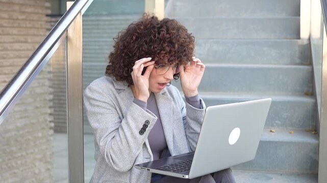 Dedicated and Focused Professional Woman Engaged in Working on Her Laptop in the Great Outdoors
