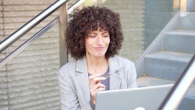 A Thoughtful and Innovative Young Professional Working Diligently on a Laptop While Outdoors