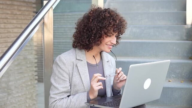 A Business Woman Engaged in Working on Her Laptop While Enjoying the Outdoors Environment
