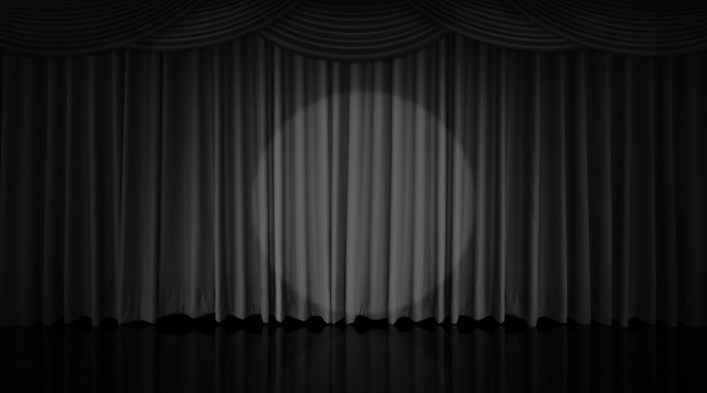 A black curtain hung on the theater stage, illuminated by spotlights.