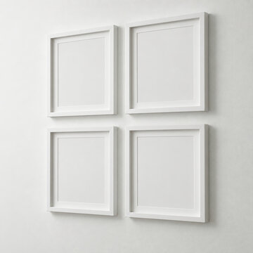 Four blank white picture frames in 2x2 grid on white gallery wall, white frame color, isolated on white wall.