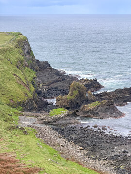 Rugged volcanic rocks and grassy cliffs meet the North Atlantic along the dramatic Causeway Coast near Giant's Causeway in Northern Ireland.