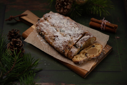 German stollen cake with marzipan, Christmas bread with pine decoration