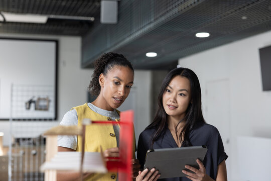 Women Discussing Design Projects in Modern Office Setup