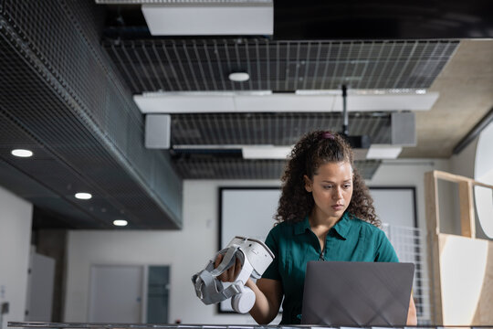 Confident woman experimenting with VR tools at work