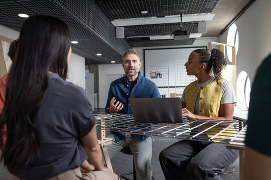 Group discussion in modern workspace about technology innovation