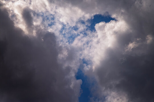 Dramatic Dark Storm Clouds With Patches Of Blue Sky And Light Breaking Through