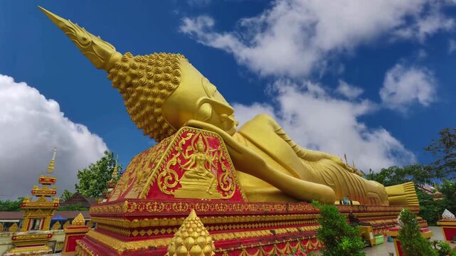 Laos Golden Reclining Buddha adjacent to Pha That Luang in Vientiane, LaosReclining Buddha statue outside temple next to the iconic Pha That Luang stupa in Vientiane, Laos.
