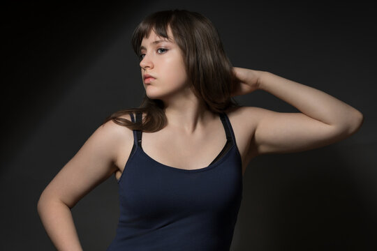 Beautiful teenage girl posing in beauty style on dark background