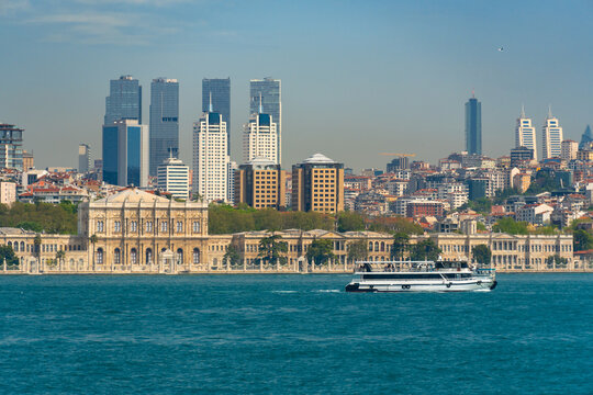 Panoramic view of Dolmabahce Palace and modern skyline with skyscrapers along the Bosphorus strait in Istanbul Turkey