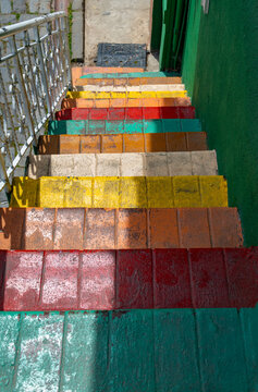 Colorful painted brick stairs leading down in an old street of Istanbul, Turkey, featuring vibrant hues and bright sunlight shadows
