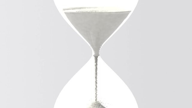 Streaming glass hourglass moving fine white sand through narrow neck in studio, gravity pulling