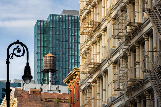 Historic cast iron building with fire escapes and a rooftop water tower in SoHo, Manhattan, New York City