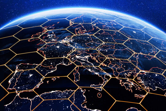 Planet Earth at night focused on Europe with glowing city lights and a golden hexagon grid overlay. Concept for 5G global communication, satellite network coverage, and cybersecurity.