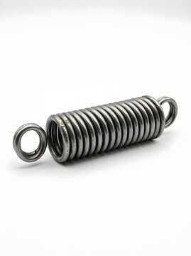 Industrial heavy duty metal extension spring lying on white background