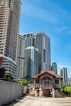Skyline of Kuala Lumpur next to a small building, Malaysia