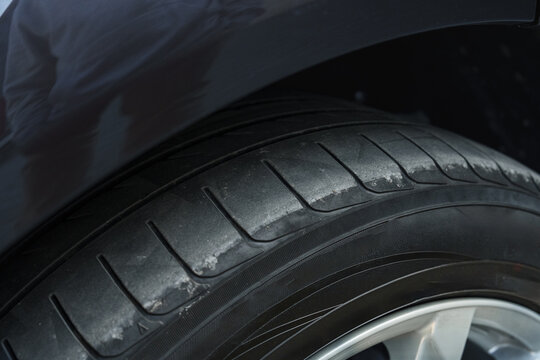 Close look at a worn tire on a vehicle showing signs of use and age