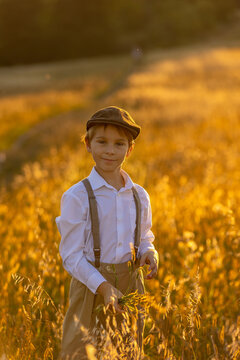 Sweet preteen child, boy, playing in a field on sunset with kite and old vingate car, walking with grandmother in the countryside