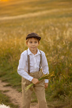 Sweet preteen child, boy, playing in a field on sunset with kite and old vingate car, walking with grandmother in the countryside