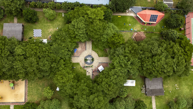 Aerial view of Ndubuisi Kanu Park featuring lush green trees, paved walkways, a central circular area, and various recreational facilities in Ikeja, Lagos, Nigeria.