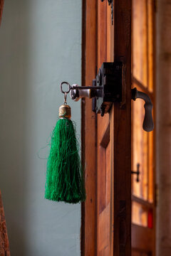 A green silk tassel dangles from an antique key in an old wooden door lock at the historic Palmyra Hotel, Baalbek-Hermel Governorate, Baalbek, Lebanon