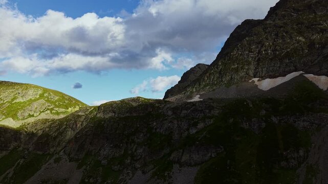 Rugged Mountain Valley with Steep Rocky Cliffs and Snow