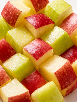 Diagonal stripes pattern of chopped red and green apple fruit cubes