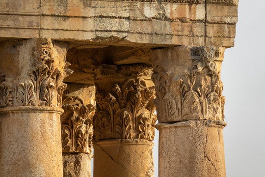 Several Corinthian columns with carved acanthus capitals stand side by side at the ancient Roman temple ruins, Baalbek-Hermel Governorate, Baalbek, Lebanon