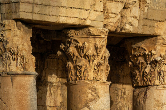 A carved stone capital features ornate ram head decoration among the ruins of the ancient Roman temple, Baalbek-Hermel Governorate, Baalbek, Lebanon
