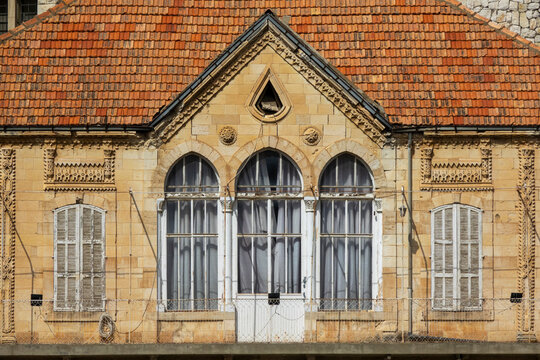 A traditional Lebanese stone house features a triple-arched window beneath a red tile roof, Beqaa Governorate, Zahle, Lebanon