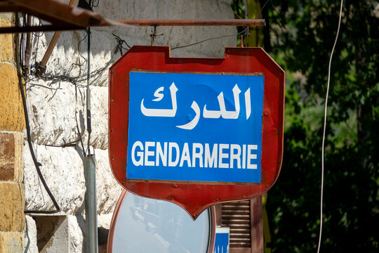 A bilingual red and blue sign marks the entrance of a gendarmerie police station, North Governorate, Tripoli, Lebanon